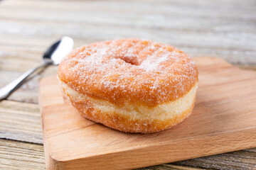 A view of a sugar donut, in a restaurant or kitchen setting.