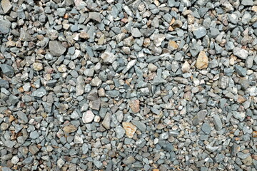 Gray gravel stone wallpaper background backdrop. Concrete rough grunge industrial texture pattern.