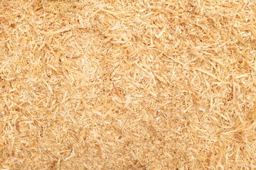 Brown wood sawdust shavings and flakes background wallpaper for a texture pattern backdrop.