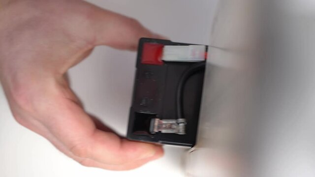 Removing an old, used, or used battery from an uninterruptible power supply. 