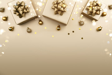 Merry Christmas card made of golden Christmas gift boxes with bows on gold background. Xmas and New Year holiday banner with bokeh, light, glitter. Flat lay, top view