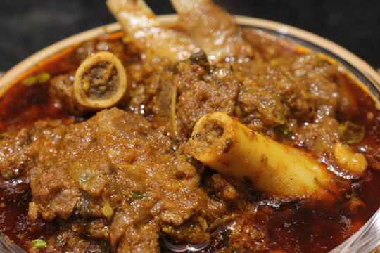 Indian Spicy mutton curry in a Glass bowl on white background