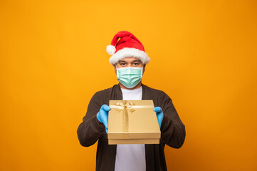 Young asian man in christmas day holding the present gift box on