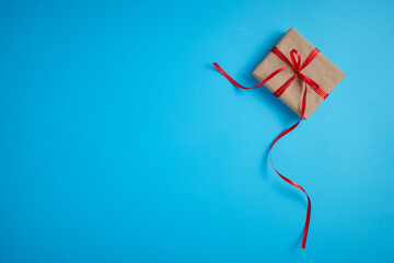 Gift box with a red bow on a blue