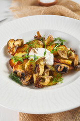 Fried potato with mushrooms and sour cream