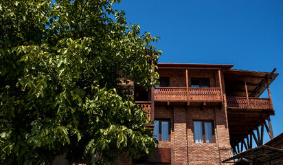 Fototapeta premium View on picturesque houses of the city of Sighnaghi. Beautiful retro old town. Old architecture charming atmosphere. Traditional houses in the old town.