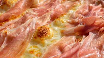 Close up to a delicious Italian ham pizza with mozzarella (no tomato). Pizza cooked in a wood oven