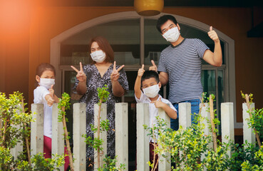 asian family wearing protection mask standing like home quarantine