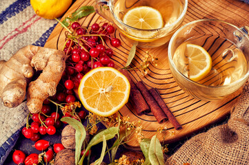 Cup of tea with lemon and berries on the table