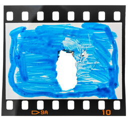 damaged or ripped 35mm film snip or strip with deep cutting hole and color mark on the frame cell....