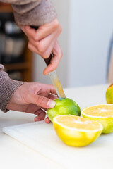 Hands of a young woman splitting a lemon