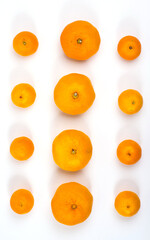 Tangerines spread out in a square on a white background, close-up, copy space, isolated