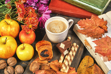 A Cup of hot autumn coffee with fruit and sweets on the table
