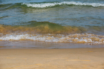 Sea surf, waves rolls on a sandy beach