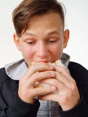 portrait pimply teenager eating fast food shawarma