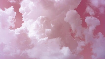 Thick white clouds swirl like smoke in the pink sky