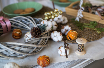 New year or Christmas wreath made of twigs, cinnamon sticks, cones and Christmas toys . Family made. Wooden decor 