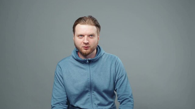 Video of sedative blond man in blue sweatshirt