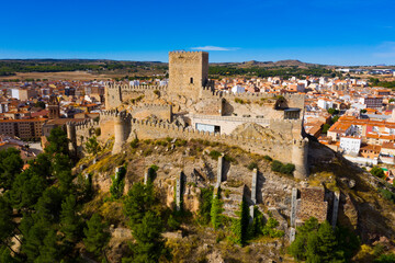 Fototapeta na wymiar View from drone of historic center of Spanish city of Almansa overlooking ancient fortified Castle and bell-tower of Roman Catholic Church, province of Albacete