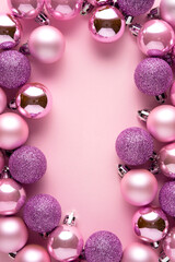 Creative concept holiday celebration photo of christmas toys balls decoration on pink background.