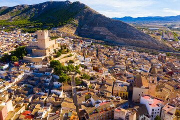 Scenic view from drone of historic center of Spanish city of Villena overlooking fortified Castle...