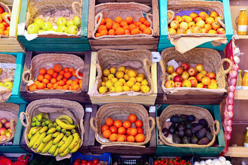 Large assortment of fresh colorful fruits on shelves in supermarket.