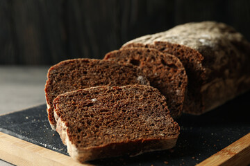 Board with fresh rye bread, close up