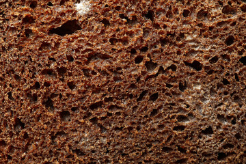 Fresh baked dark bread on whole background, close up