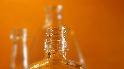Fototapeta na wymiar abstract background of glass bottles on orange background