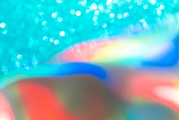 Abstract mixed holographic blue ai aqua blurred glitter shiny background. Liquid neon rainbow foil unicorn style. Bright sparkling bokeh style. Festive Christmas holiday iridescent futuristic texture.