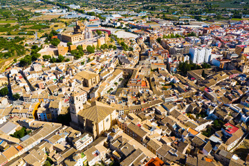 Fototapeta na wymiar Scenic aerial view of residential areas and ancient Castle in small Spanish town of Caravaca de la Cruz on sunny autumn day..