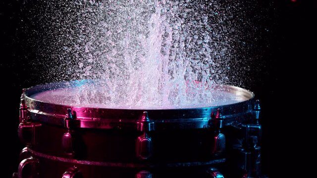 Super slow motion of drummer banging on drum with water splashing. Filmed on high speed cinema camera , 1000 fps.