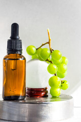 Grape seed oil in glass bottle with fresh grape