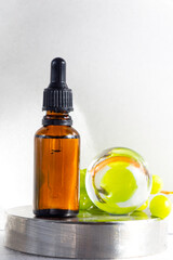 Grape seed oil in glass bottle with fresh grape