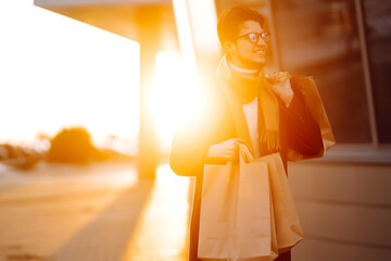 Young man after autumn shopping walking around the city. Consumerism, black friday, sales, lifestyle concept.