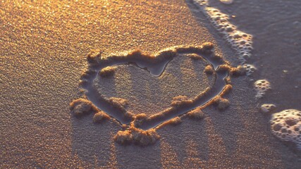Heart Shapes Being Drawn on Sandy Beach and Wiped Out by Sea Wave at Sunset