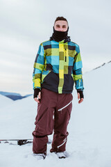 Fototapeta na wymiar Boy in coat on a snowy mountain