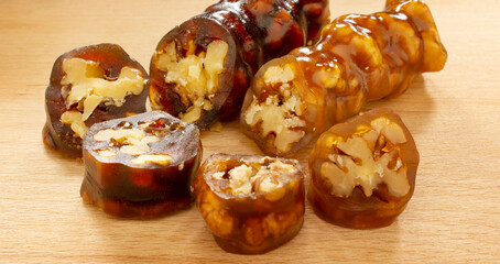 Walnuts on a string dipped in starch grape molasses. Churchkhela. Walnut sujuk.