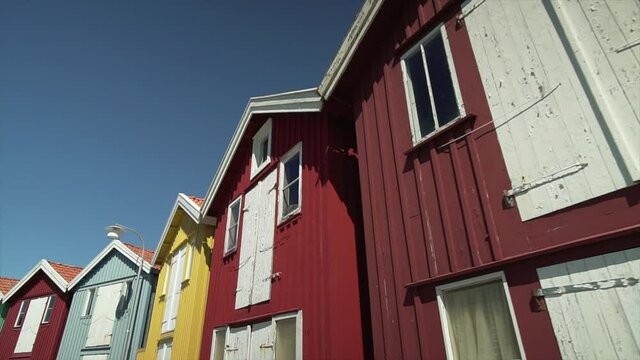 Sweden fishing hut cottages. wooden cabins on pier in Swedish touristic city. Popular object for pictures. Smooth walking gimbal shot in slow motion