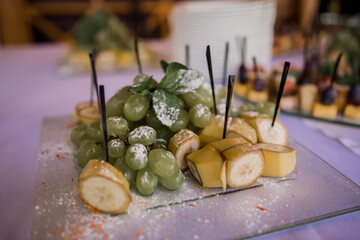bananas and grapes on buffet table in a restaurant
