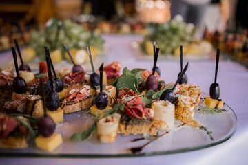 snacks on a buffet table with olives