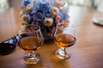glasses with cognac on a wooden table