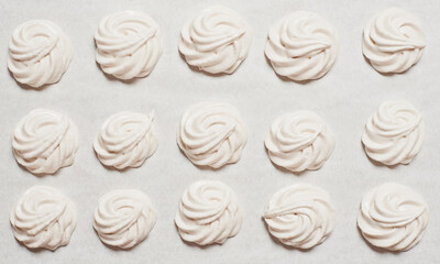Cooked homemade meringue cookies on baking paper