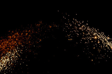 blurry sparks from fireworks on black background
