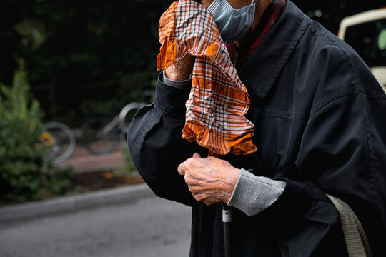Closeup Focus Shot Of An Old Man Wiping His Face With A Handkerchief