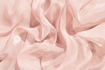 Pink abstract satin background with folds.