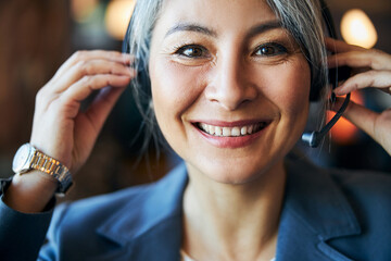 Beautiful cheerful woman wearing headset with microphone