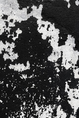 Abstract black and white wall texture with peeling paint.