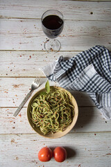 Pasta in a bowl along with a drink on a background