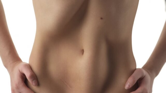 Front closeup of a womans belly performing abdominal muscles exercise. Losing weight and getting a flat tummy.
